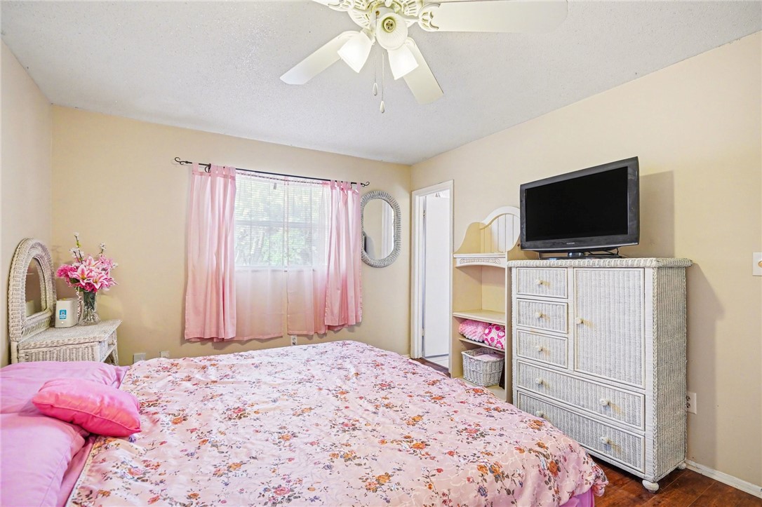 748 Cranbrook Avenue Northeast Palm Bay, FL 32905 - Photo 14 of 26 a bedroom with a bed and a flat screen tv