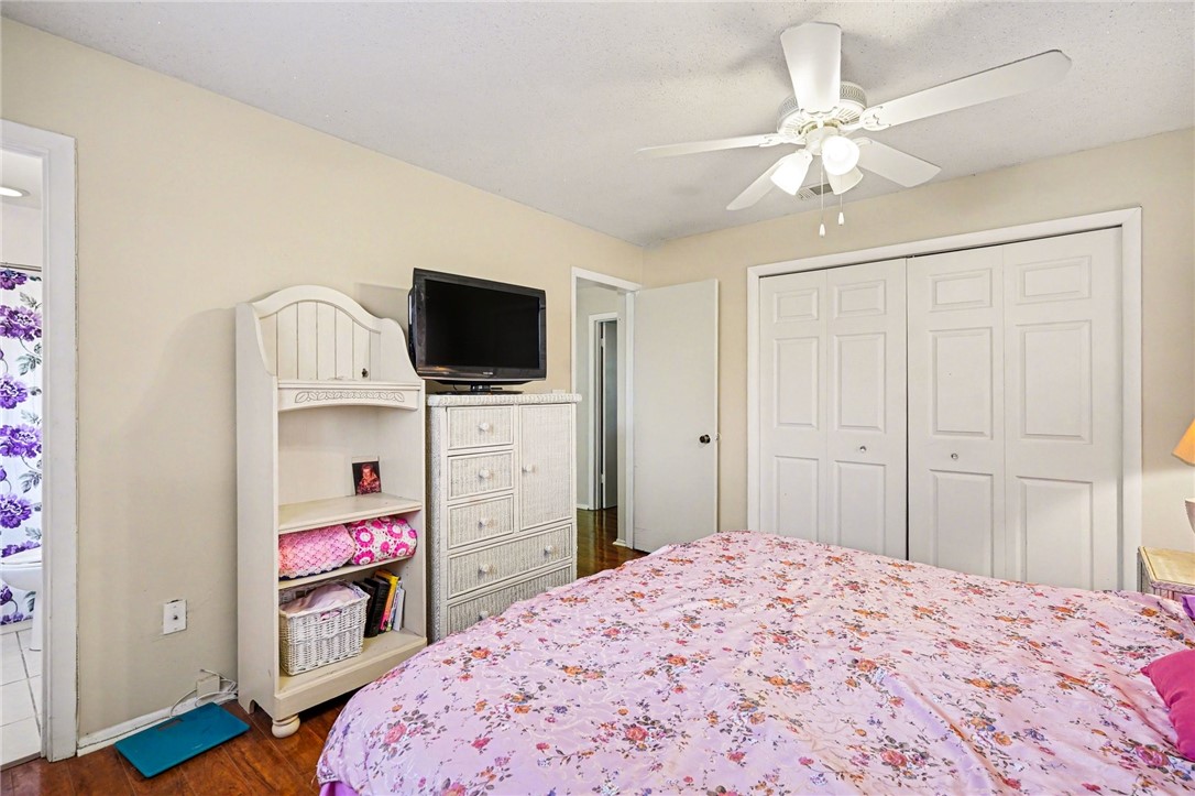 748 Cranbrook Avenue Northeast Palm Bay, FL 32905 - Photo 15 of 26 a bedroom with a bed and a flat screen tv