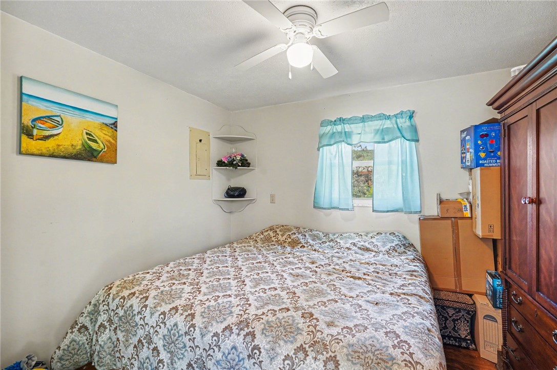 748 Cranbrook Avenue Northeast Palm Bay, FL 32905 - Photo 17 of 26 a bedroom with a bed and a chandelier