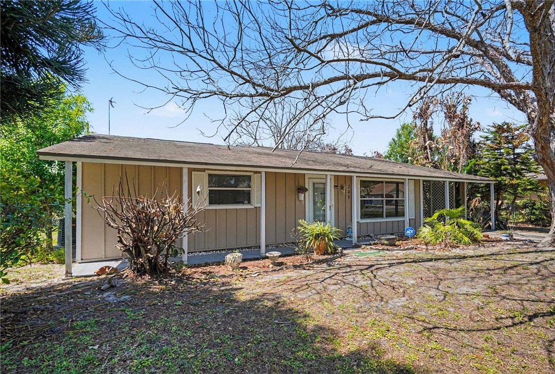 748 Cranbrook Avenue Northeast Palm Bay, FL 32905 - Photo 2 of 26 a front view of a house with garden