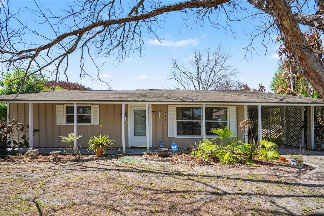 748 Cranbrook Avenue Northeast Palm Bay, FL 32905 - Photo 4 of 26 a front view of a house with garden