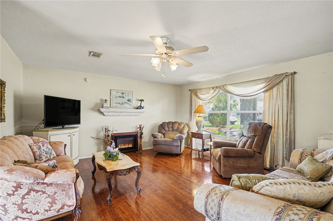 748 Cranbrook Avenue Northeast Palm Bay, FL 32905 - Photo 6 of 26 a living room with furniture a flat screen tv and a large window