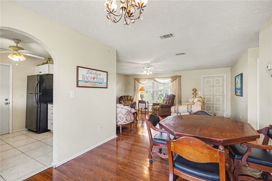 748 Cranbrook Avenue Northeast Palm Bay, FL 32905 - Photo 9 of 26 a view of a dining room with furniture and a chandelier