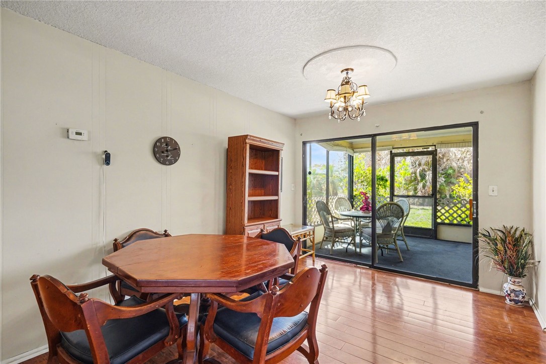 748 Cranbrook Avenue Northeast Palm Bay, FL 32905 - Photo 10 of 26 a view of a dining room with furniture window and wooden floor
