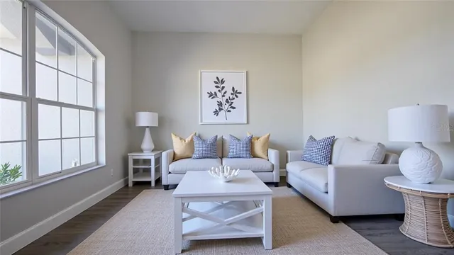 an empty room with a window and a ceiling fan