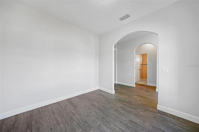 a view of an empty room and wooden floor