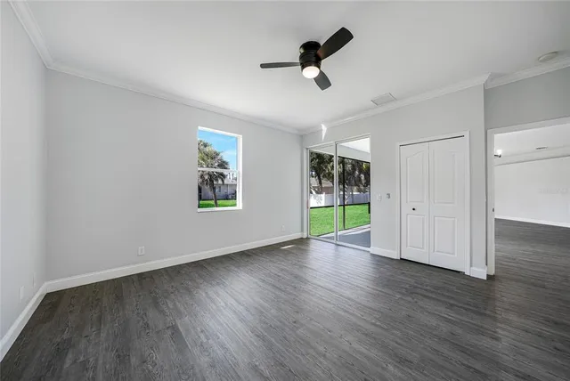 a view of a house with a big yard and potted plants