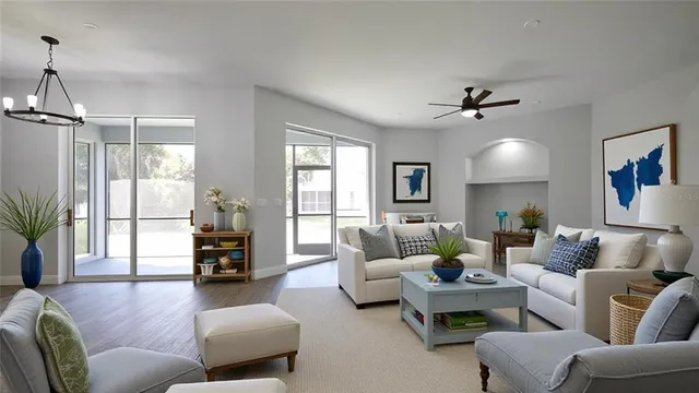 a living room with furniture and a chandelier
