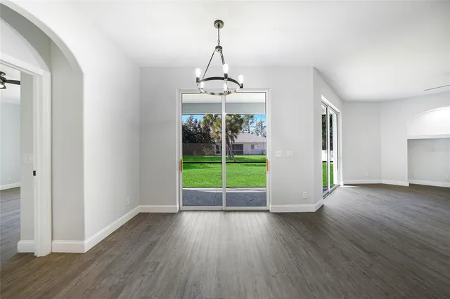 a view of a room with wooden floor fireplace and a window