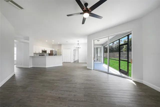 a view of a kitchen with a sink and dishwasher a refrigerator with wooden floor
