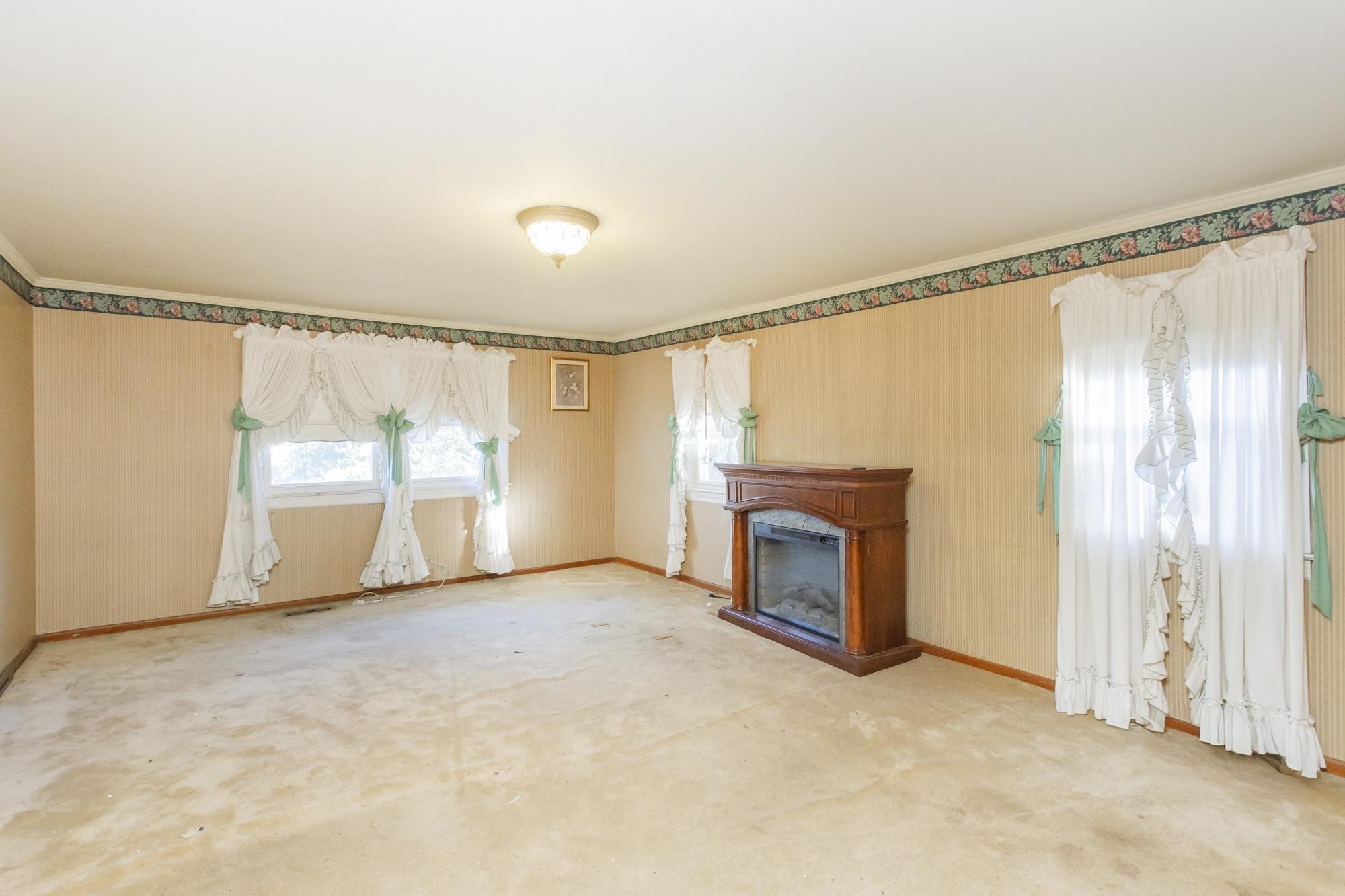1700 Riverside Road Old Hickory, TN 37138 - Photo 18 of 59 a view of an empty room with a fireplace and a window