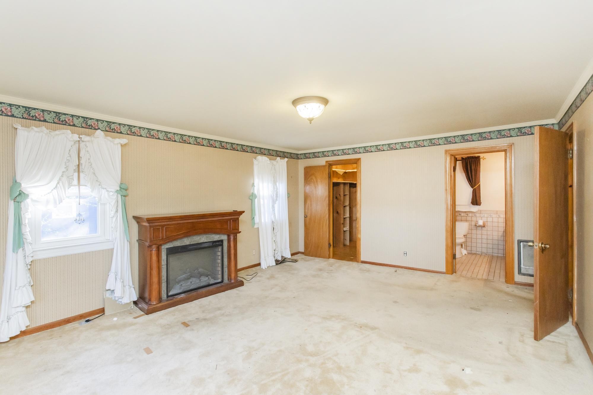 1700 Riverside Road Old Hickory, TN 37138 - Photo 19 of 59 a view of an empty room with a fireplace and a window