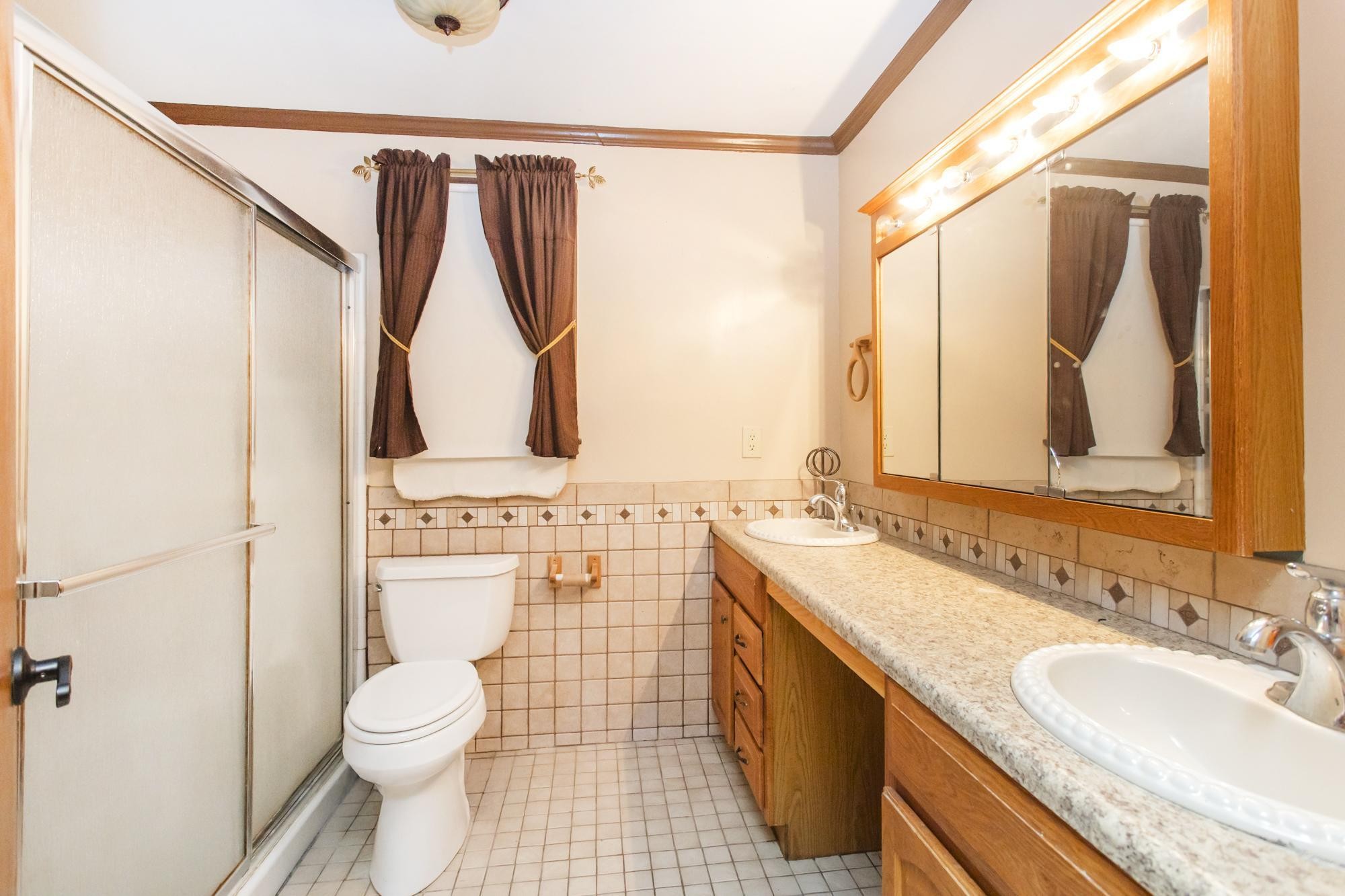 1700 Riverside Road Old Hickory, TN 37138 - Photo 22 of 59 a bathroom with a granite countertop sink toilet and shower
