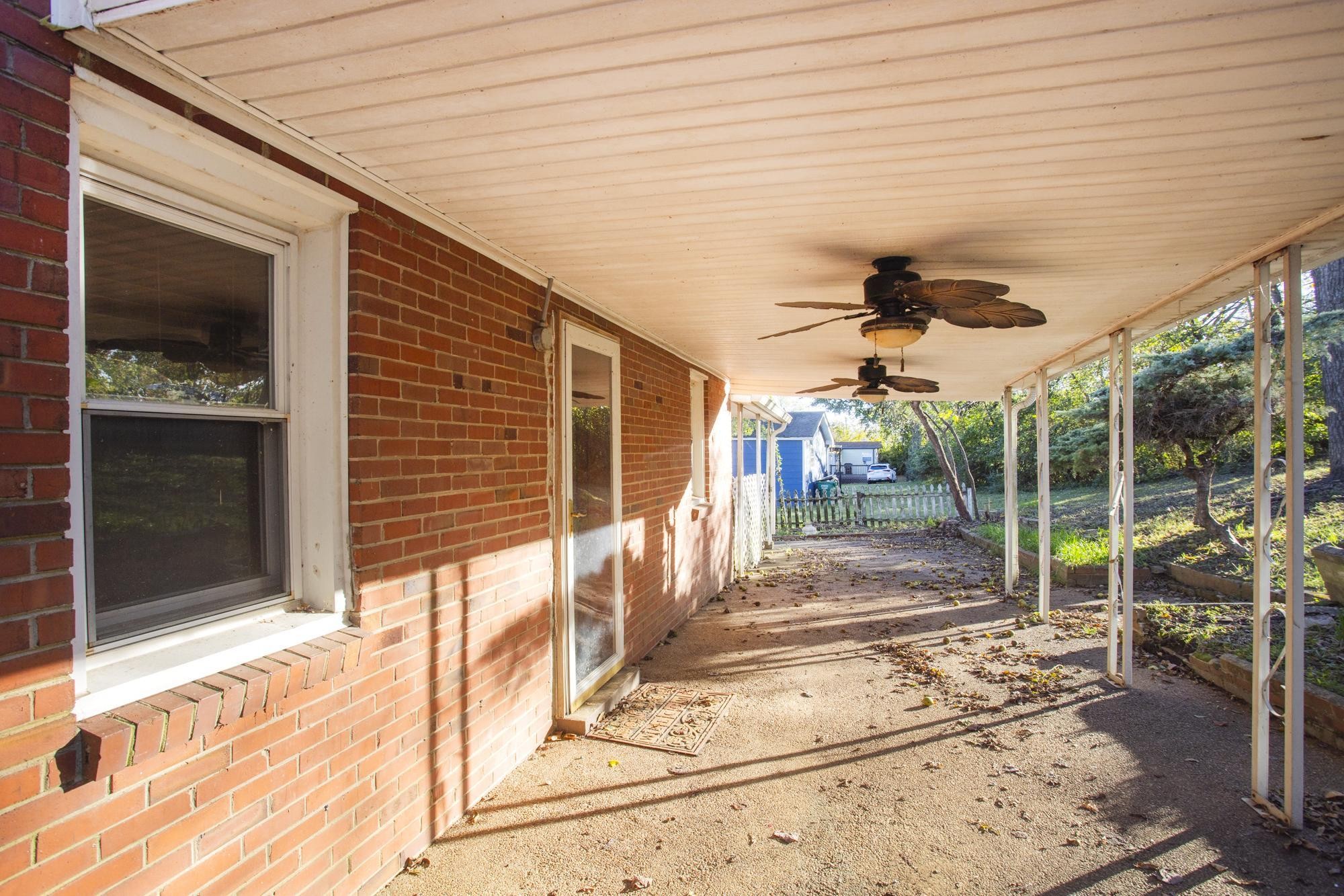 1700 Riverside Road Old Hickory, TN 37138 - Photo 30 of 59 a view of a porch with a floor to ceiling window and potted plants