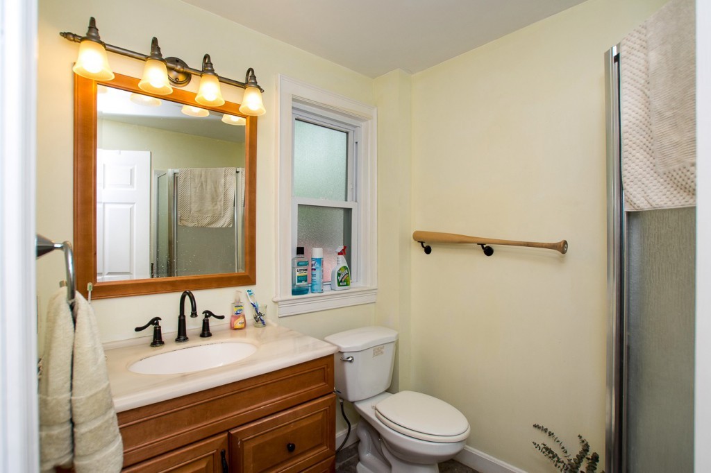 228 Langley Road Newton, MA 02459 - Photo 12 of 30 a bathroom with a sink vanity mirror and toilet