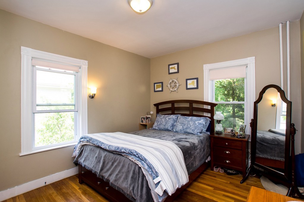 228 Langley Road Newton, MA 02459 - Photo 19 of 30 a bedroom with a bed and a window