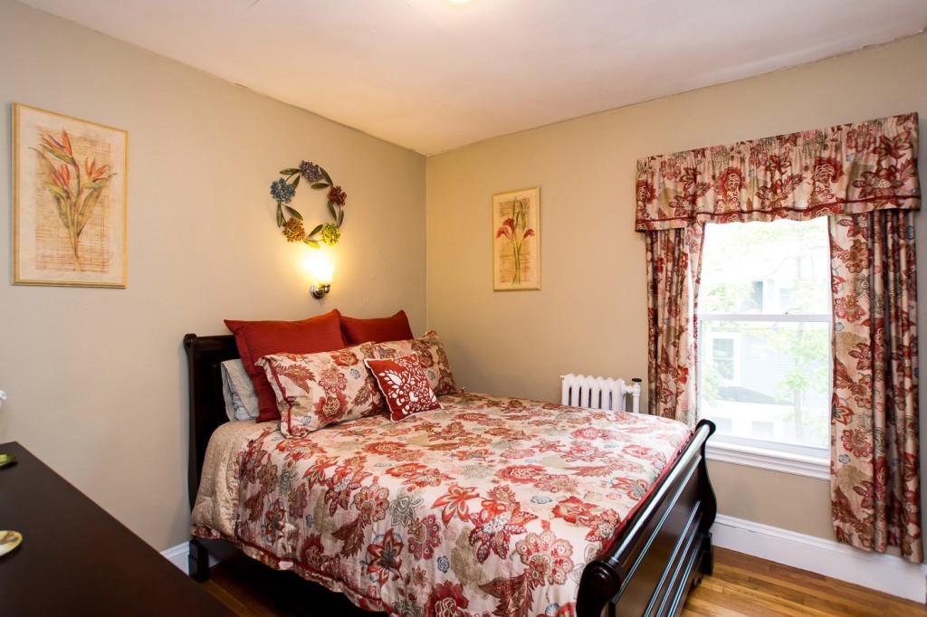 228 Langley Road Newton, MA 02459 - Photo 22 of 30 a bedroom with a bed and wooden floor