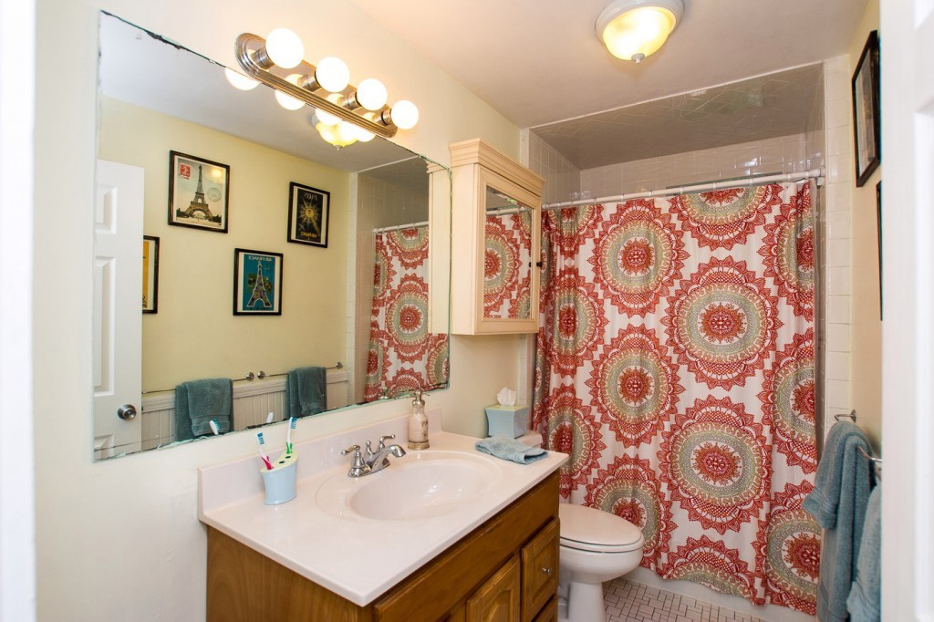 228 Langley Road Newton, MA 02459 - Photo 23 of 30 a bathroom with a sink toilet and shower