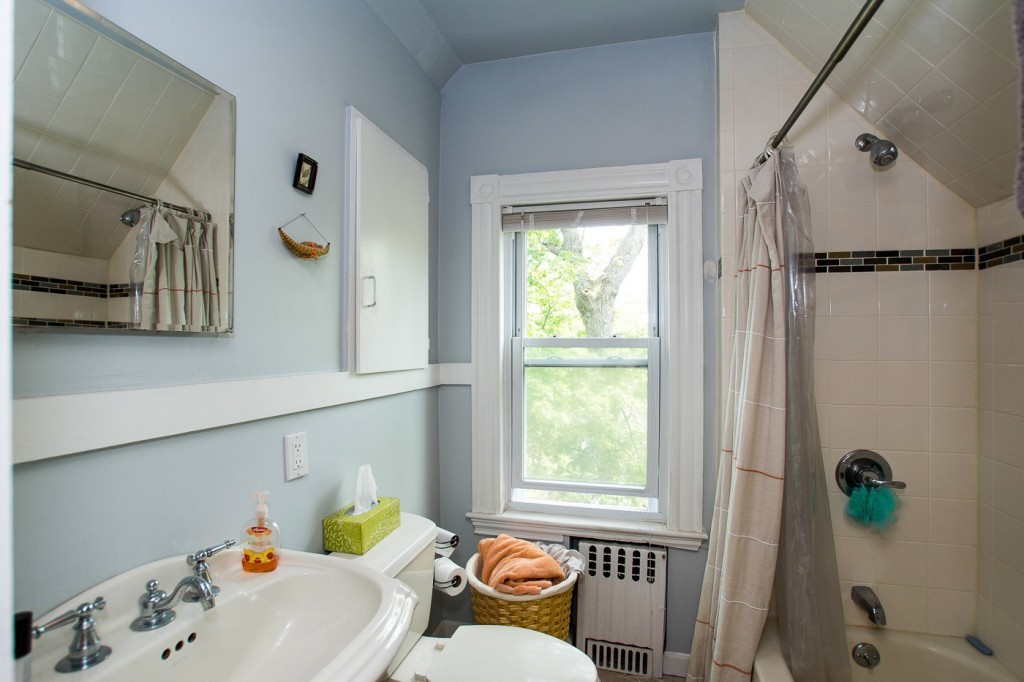 228 Langley Road Newton, MA 02459 - Photo 29 of 30 a bathroom with a sink and a window