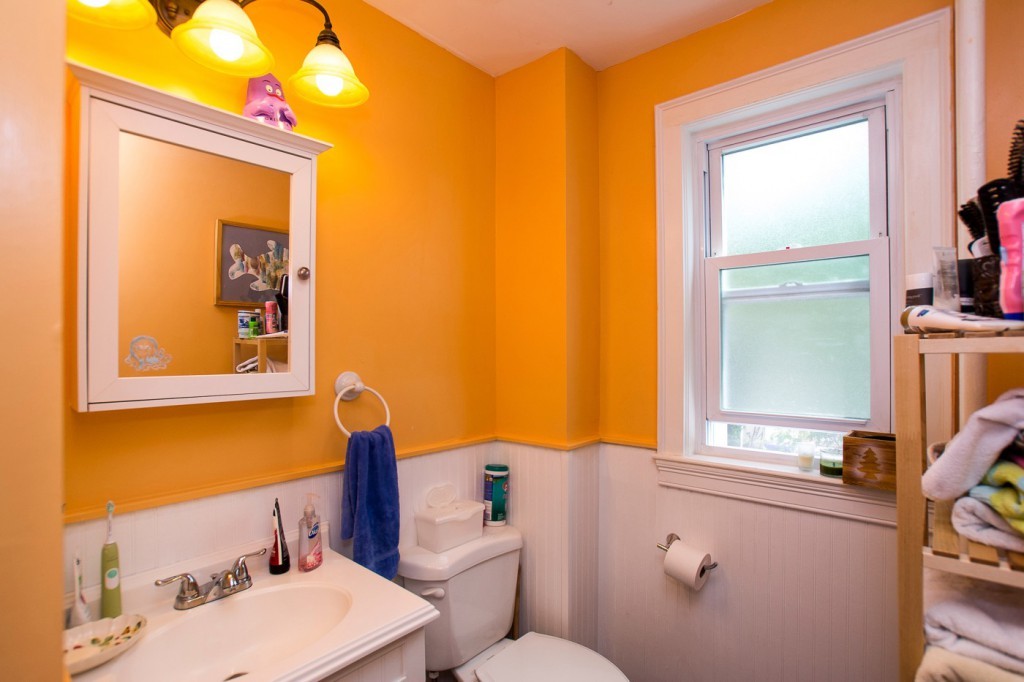 228 Langley Road Newton, MA 02459 - Photo 8 of 30 a bathroom with a sink and a mirror