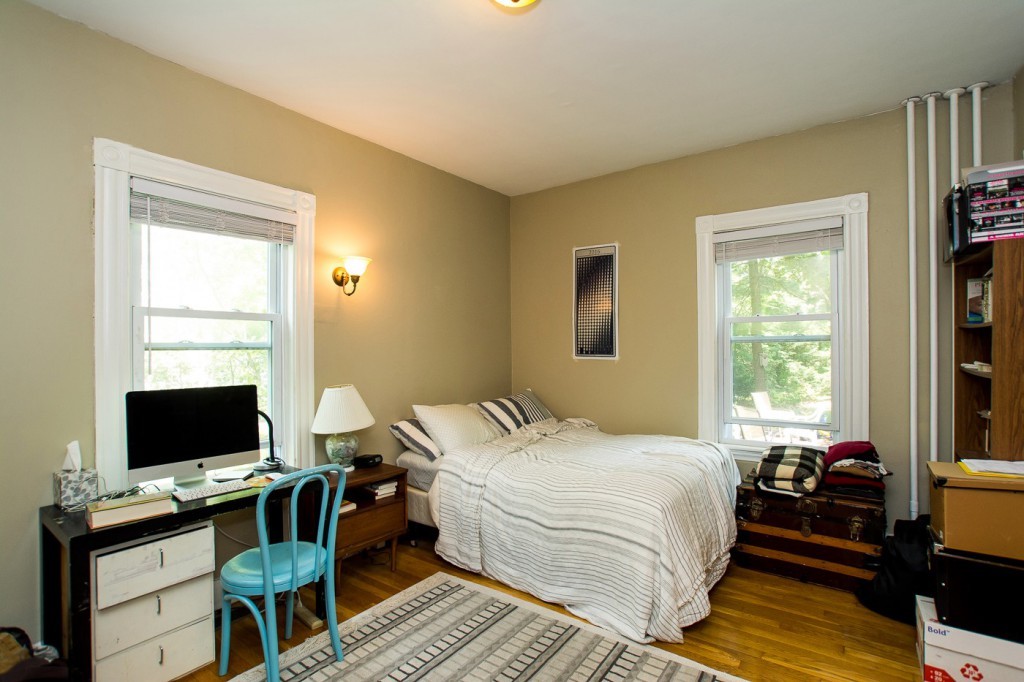 228 Langley Road Newton, MA 02459 - Photo 10 of 30 a bedroom with a bed and a flat screen tv