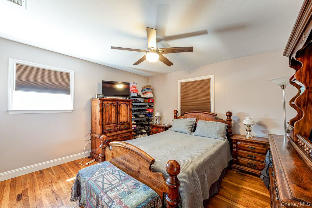 89 Cheltenham Road West Babylon, NY 11704 - Photo 14 of 26 a bed room with a bed and a flat tv screen