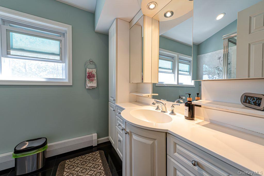 89 Cheltenham Road West Babylon, NY 11704 - Photo 16 of 26 a bathroom with a sink a toilet and vanity