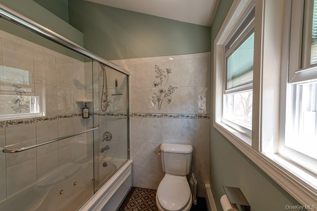 89 Cheltenham Road West Babylon, NY 11704 - Photo 17 of 26 a bathroom with a toilet sink and shower