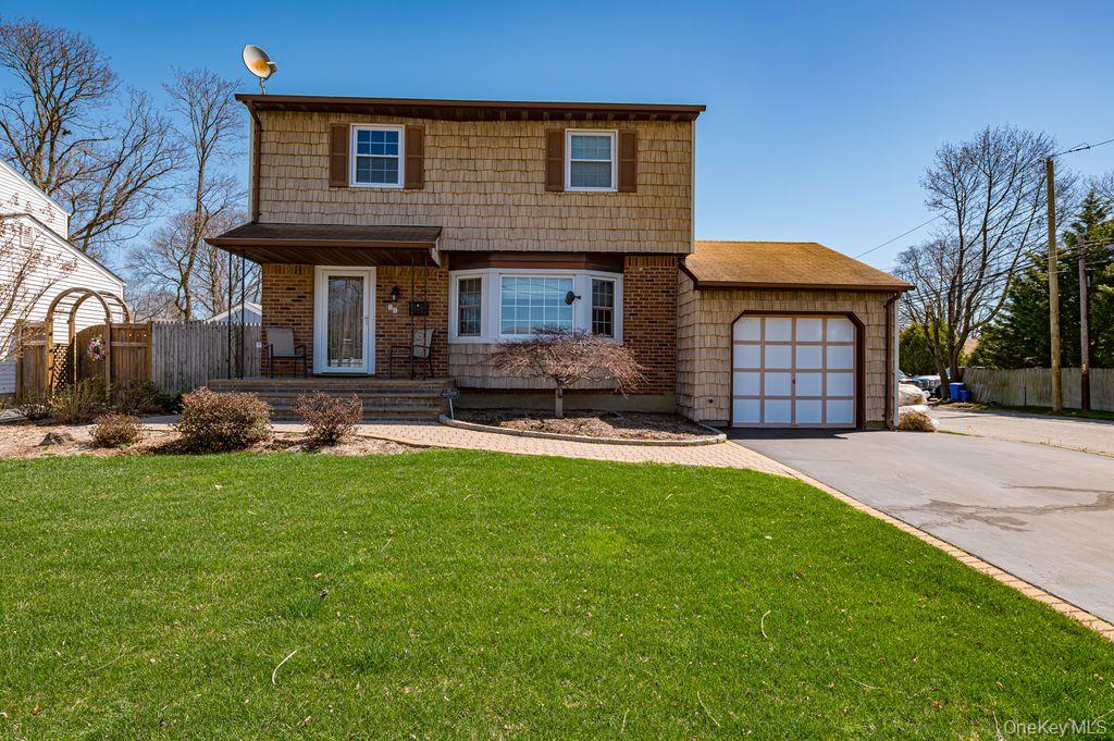 89 Cheltenham Road West Babylon, NY 11704 - Photo 2 of 26 a front view of a house with a yard