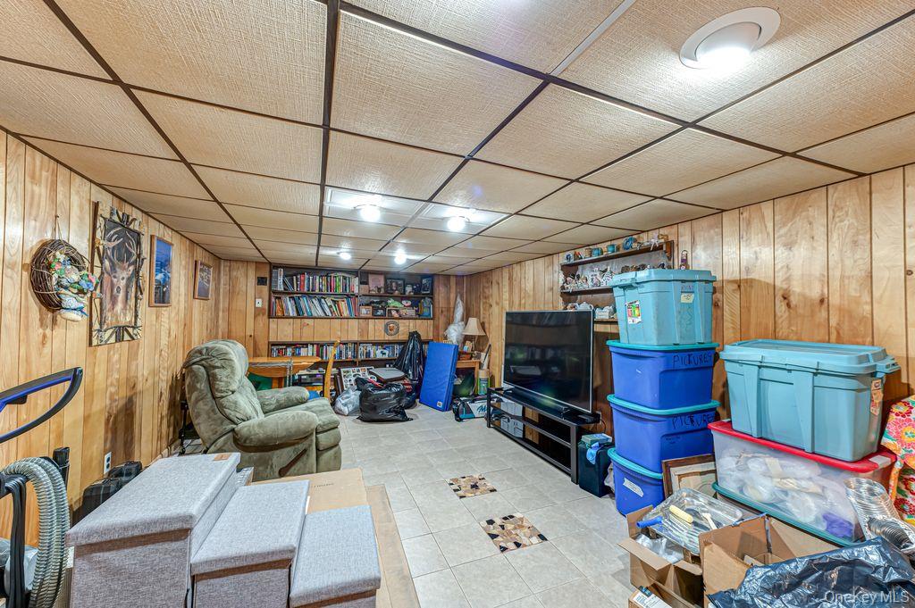 89 Cheltenham Road West Babylon, NY 11704 - Photo 26 of 26 a living room with furniture and a flat screen tv