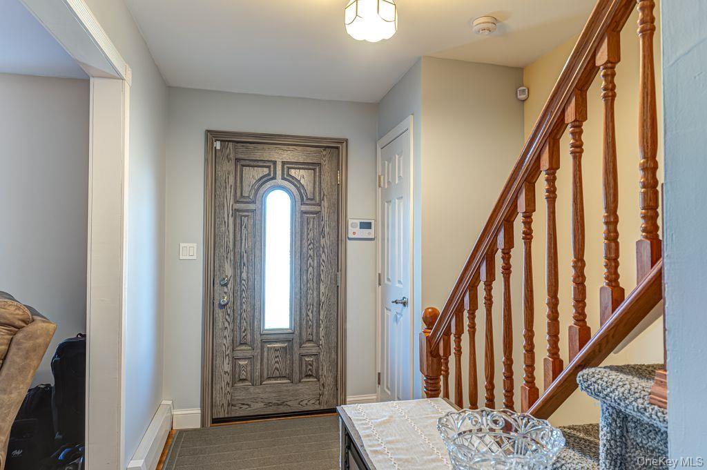 89 Cheltenham Road West Babylon, NY 11704 - Photo 4 of 26 a view of a hallway with wooden floor and entryway