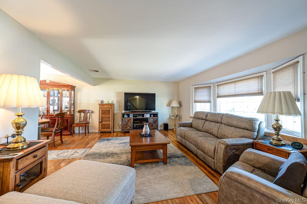 89 Cheltenham Road West Babylon, NY 11704 - Photo 5 of 26 a living room with furniture and a flat screen tv