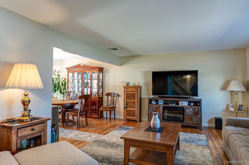 89 Cheltenham Road West Babylon, NY 11704 - Photo 6 of 26 a living room with furniture and a flat screen tv