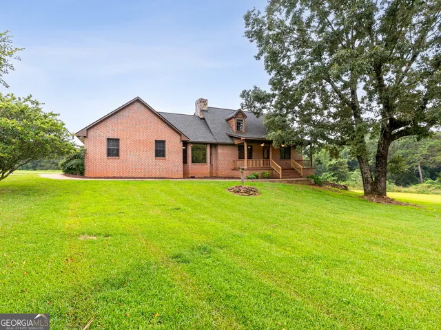 a front view of house with yard and green space