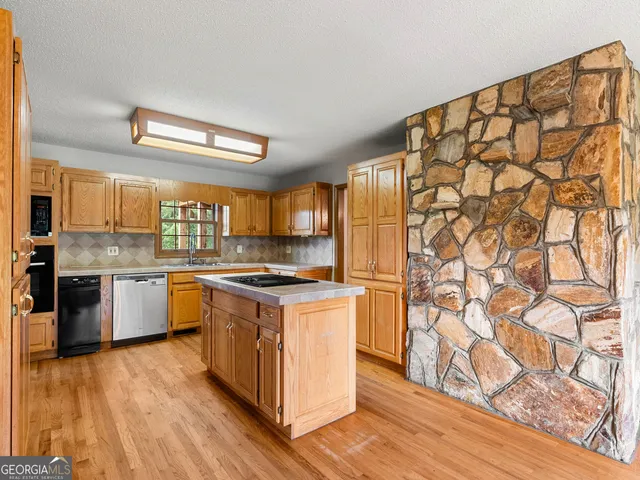 a hall with kitchen island granite countertop wooden floor