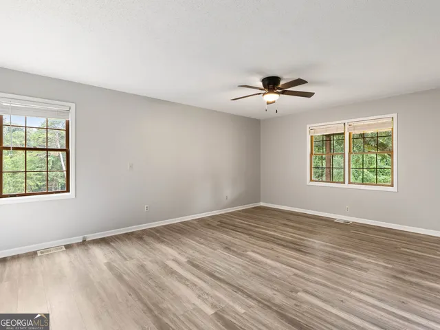 a bathroom with a double vanity sink a mirror and a bathtub
