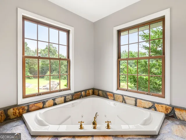 a bathroom with a sink a mirror and a shower