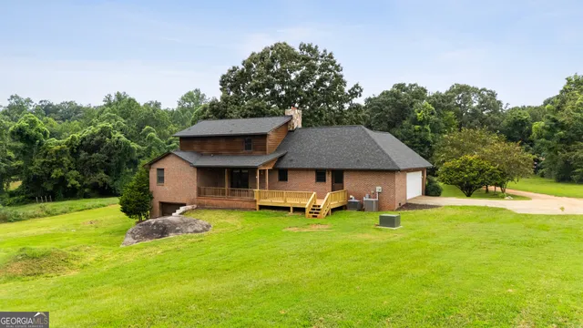 a view of a house with a yard and sitting area