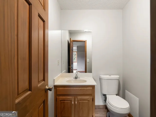 a bathroom with a sink a glass door shower and a mirror