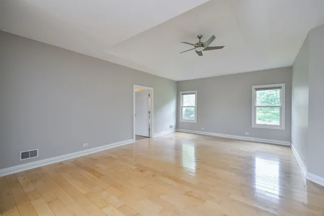 a large white kitchen with a large window
