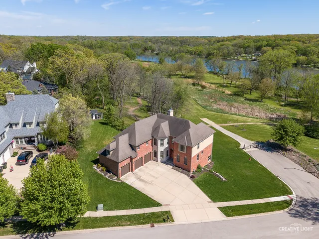 an aerial view of residential houses with outdoor space and river