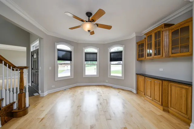 a view of a kitchen with kitchen island a large counter top stainless steel appliances and cabinets