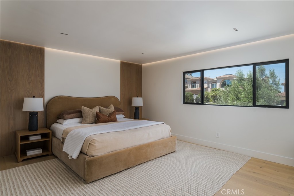 5826 Soledad Mountain Road La Jolla, CA 92037 - Photo 16 of 52 a bedroom with a large bed and a large window