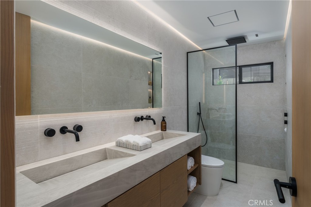 5826 Soledad Mountain Road La Jolla, CA 92037 - Photo 22 of 52 a bathroom with a sink and a mirror