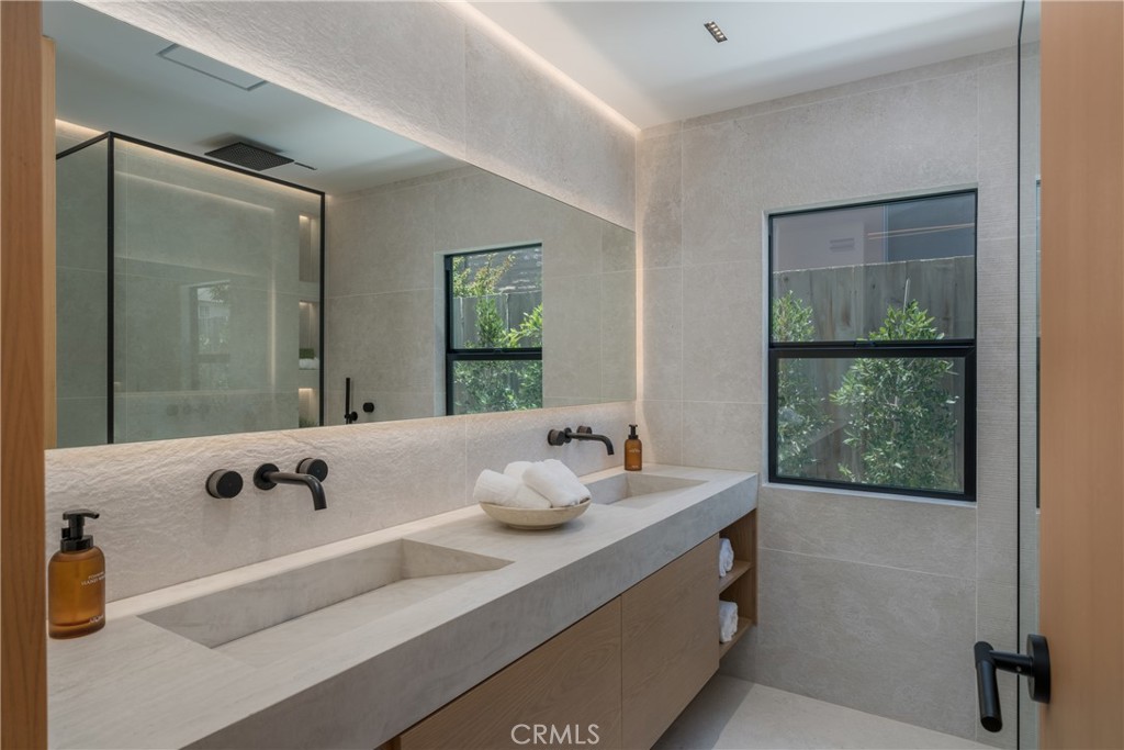 5826 Soledad Mountain Road La Jolla, CA 92037 - Photo 24 of 52 a bathroom with a tub sink and mirror