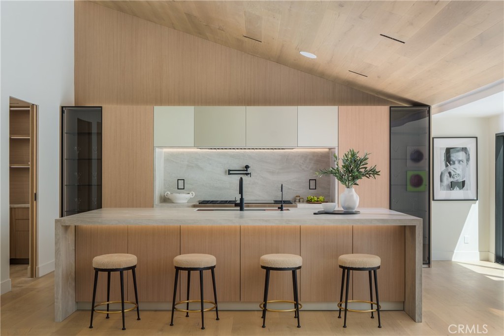 5826 Soledad Mountain Road La Jolla, CA 92037 - Photo 7 of 52 a kitchen with stainless steel appliances kitchen island granite countertop a table and chairs