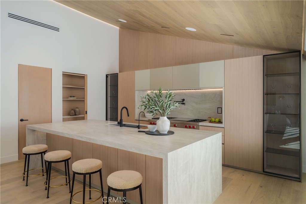 5826 Soledad Mountain Road La Jolla, CA 92037 - Photo 8 of 52 a view of kitchen island and wooden cabinets