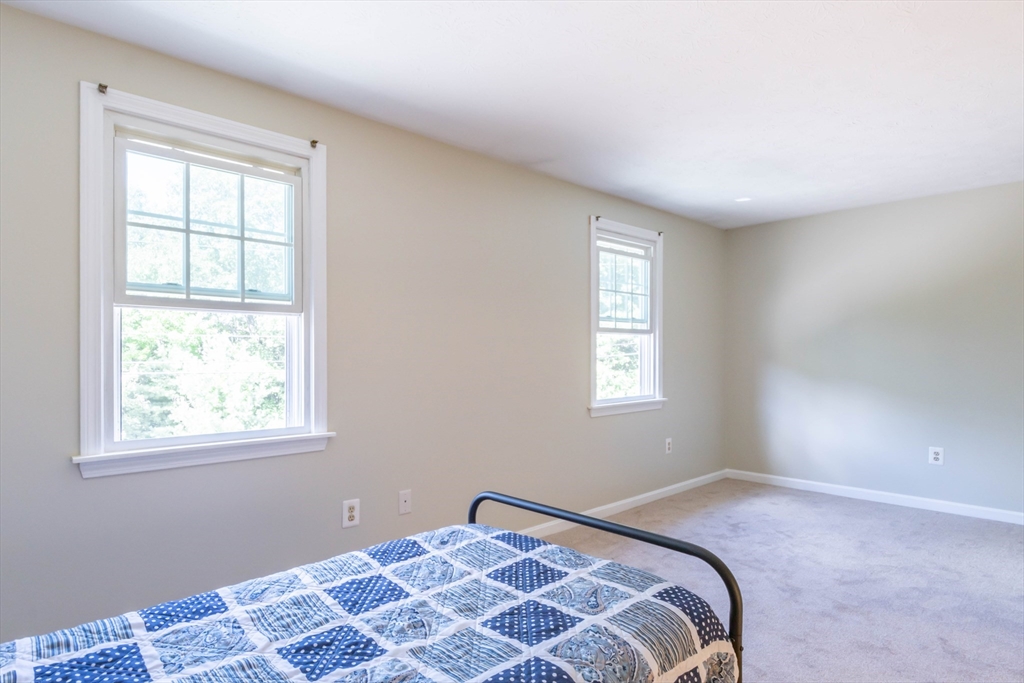 30 Lochmere Lane, Unit 30 Nashua, NH 03063 - Photo 11 of 19 a bedroom with a bed and a window