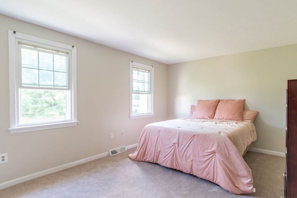 30 Lochmere Lane, Unit 30 Nashua, NH 03063 - Photo 12 of 19 a bedroom with a bed and a window
