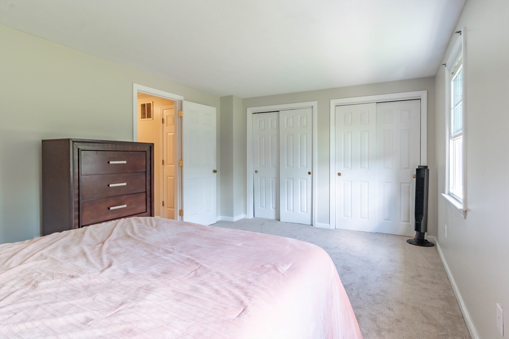 30 Lochmere Lane, Unit 30 Nashua, NH 03063 - Photo 13 of 19 a bedroom with a bed and a closet